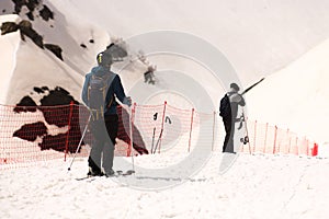 skiers and snowboarders at the beginning of the piste