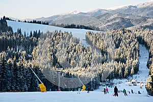 Skiers and snowboarders downhill slope at the ski resort