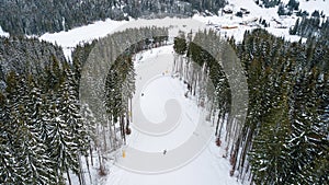 Skiers and snowboarders go down the slope in a ski resort Bukovel, Ukraine