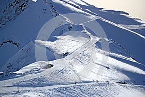 Skiers and snowboarders riding on a ski slope