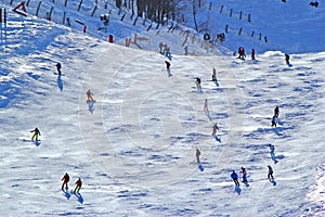 Skiers and snowboarders riding on a ski slope