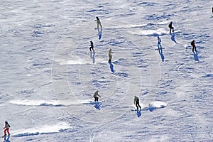 Skiers and snowboarders riding on a ski slope