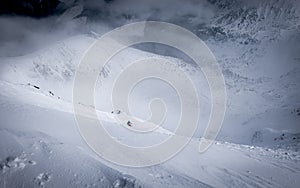 Skiers and snowboarders riding on a ski slope