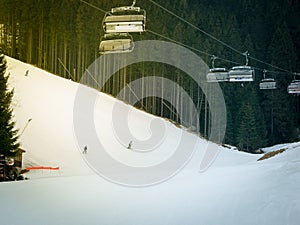 Skiers and snowboarders riding on a ski slope