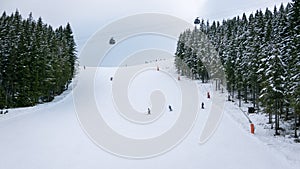 Skiers and snowboarders riding on a ski slope