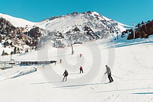 Skiers and snowboarders riding on a ski slope mountain resort