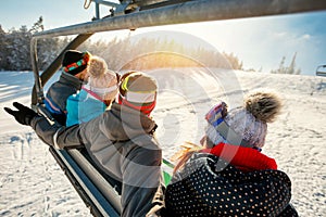 Skiers and snowboarders on ski lift in the mountain at winter va