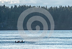 Skiff load of local fishermen near Campbell River, British Columbia, Canada