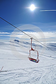 Skiing cable chair over snowy slope