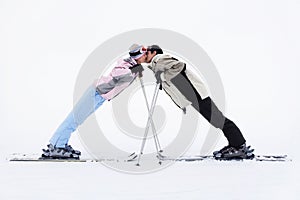 Skiing couple kissing on mountains
