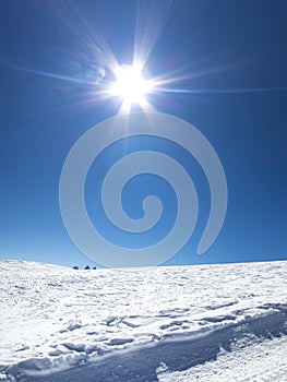 Skiing in French alps with a lot of sun