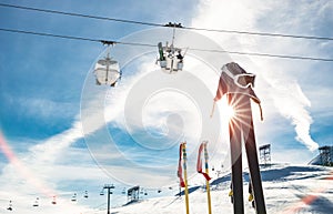 Skiing goggles and skis poles at resort glacier with chair lift