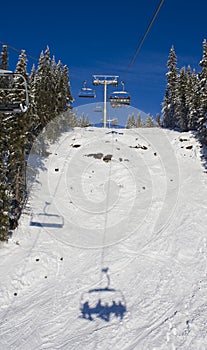 Skiing lift shadow and hill