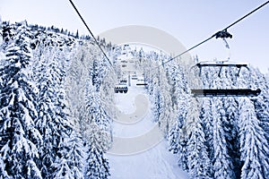 Skiing lift, snow and mountain