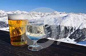 Skiing resort. Glasses with beer and white wine.