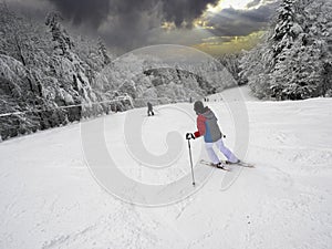 Skiing, skier, winter sport - woman skiing downhill