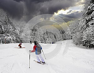 Skiing, skier, winter sport - woman skiing downhill