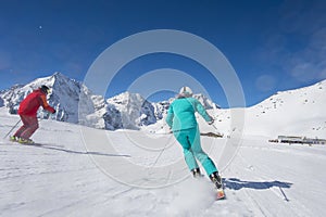 Skiing on skirun in the alps - prepared piste and sunny day