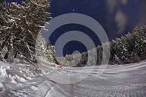 Skiing slope at night below starry sky