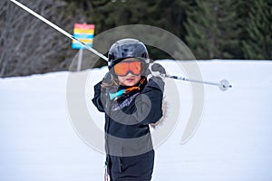 Skiing in the snow. One Asian child skier on the ski slope. Vacation in Switzerland