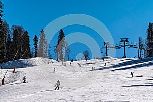 Skiing and snowboarding in the mountain area of Krasnaya Polyana ski resort, Sochi, Russia