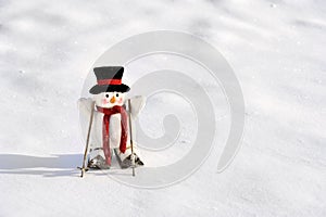 Skiing snowman in winter landscape