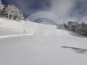 Skiing turns traces on fresh snow. Winter landscape