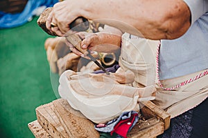 Skilful Thai art craft carpenter using hammer to chisel a wooden elephant handmade woodcraft OTOP products