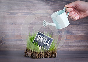 Skill concept. Fresh and green grass on wood background