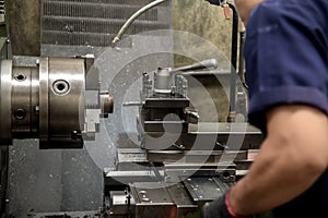The skill operator working with lathe machine .