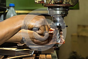 The skill operator working with NC milling machine