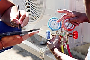 Skilled Air Conditioning Technician Repairing Heat Pump