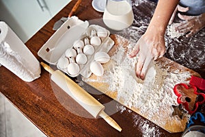 Skilled baker mixing flour for making dough