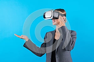 Skilled businesswoman with VR glasses standing and present idea. Contraption.