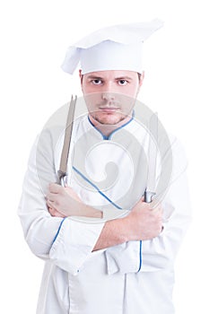 Skilled chef or cook holding two knifes or blades