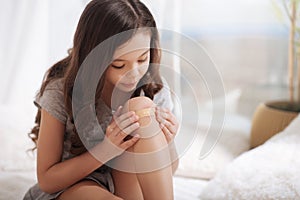 Skilled child treating her wound at home