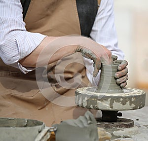 Skilled craftsman potter shaping clay