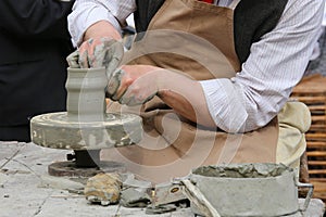 Skilled craftsman potter shaping clay to make a vase handmade