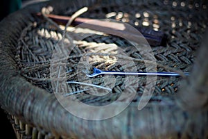 Skilled craftsman working manually a detailed bamboo wood armchair with his fingers and tools