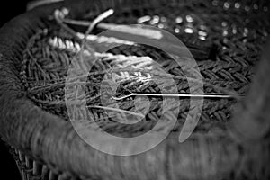 Skilled craftsman working manually a detailed bamboo wood armchair with his fingers and tools