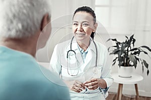 Skilled cute nurse smiling and having consultation.