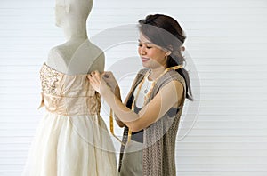 A skilled dressmaker fitting a dress on a mannequin, exhibiting utmost care and detail