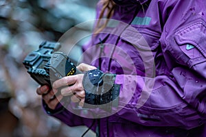 Skilled engineer in a vibrant purple uniform focusing on device adjustments