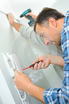 Skilled entrepreneur installing new intercom system