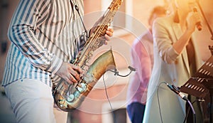A skilled jazzman plays a saxophone at a concert