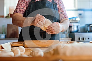 Skilled Latina Cook Creating Dough by Hand with Rolling Pin in Countryside Kitchen Scene