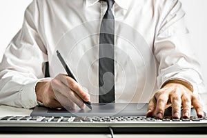 Skilled male designer drawing on a graphics tablet