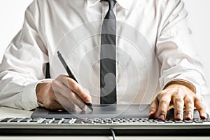 Skilled male designer drawing on a graphics tablet photo