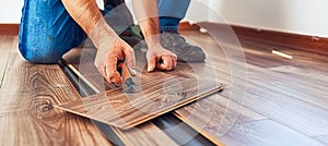 Skilled man s hands expertly installing laminate flooring for a home renovation project