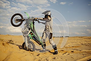 Skilled moto rider making stunt on motorbike